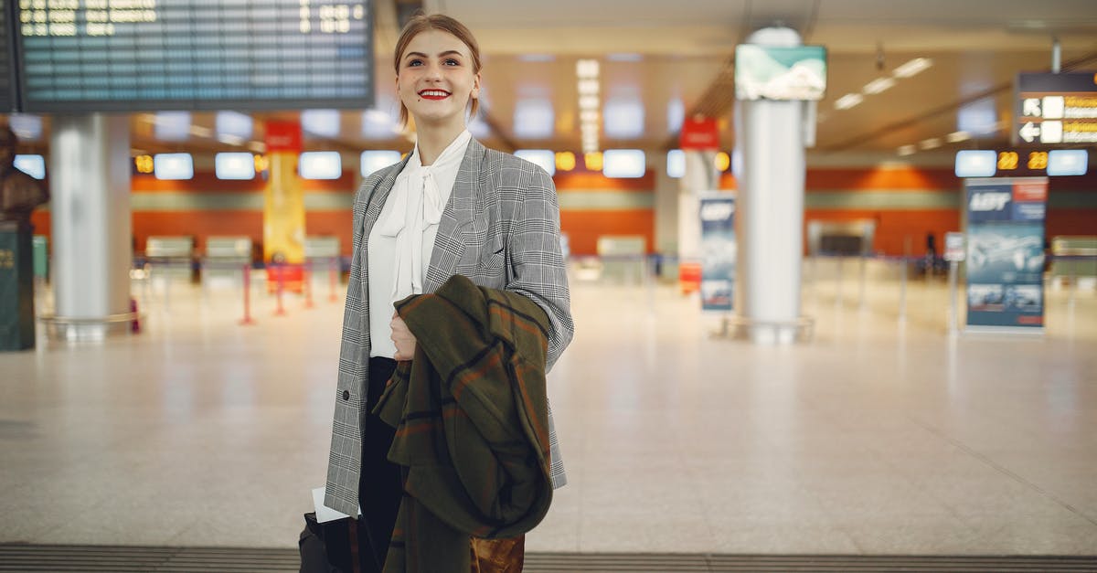 In the movie “Momentum” why is the airport Western Cape International Airport? - Happy young woman standing with baggage near departure board in airport