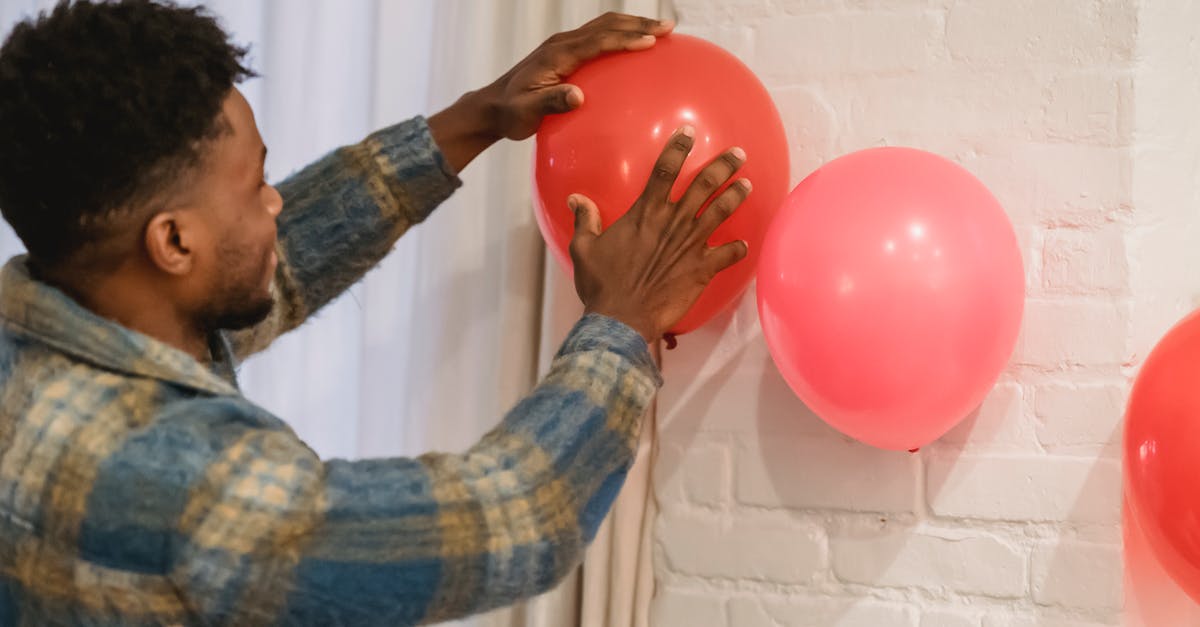 In the Spider-Man films of the last 20 years how do Spider-Man's feet stick to walls? - Black man sticking balloons to brick wall