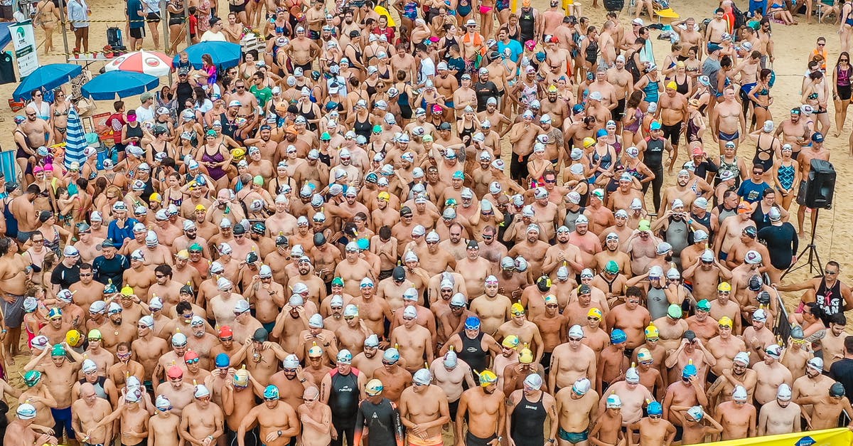 In Tombstone what is the meaning of the line spoken by Doc Holiday? - From above people in swimsuits standing together behind line tape ready to start swim marathon on seashore