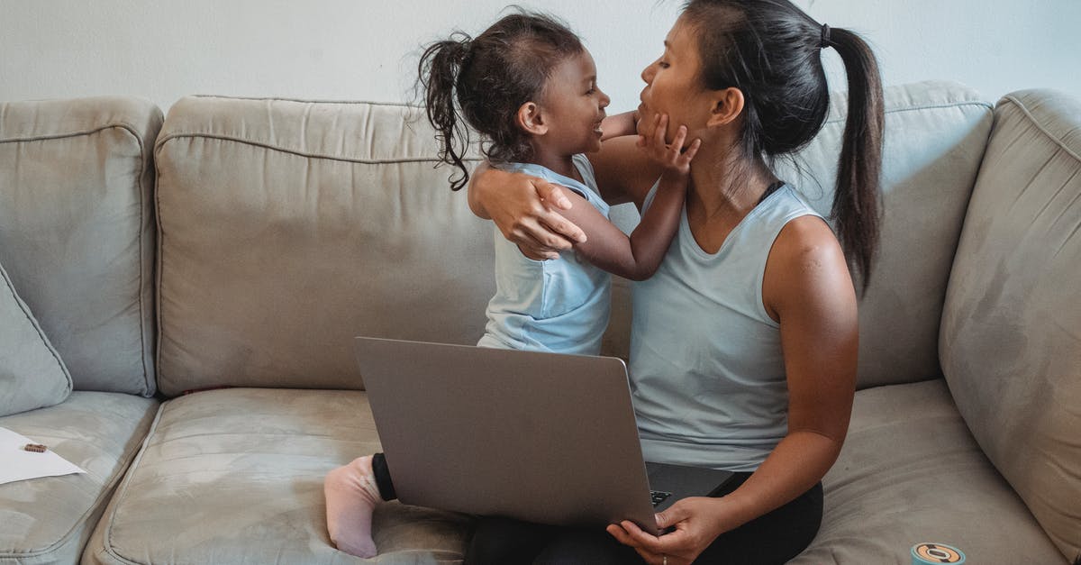 In which cartoon (if any) did Bugs Bunny use the term "nimrod"? [closed] - Young Asian mother with little daughter cuddling while watching video on laptop