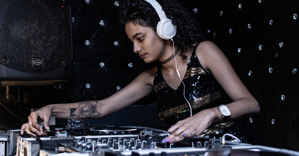 In-universe, was Eddie and Reed’s song ‘The Touch’ plagiarised by Transformers after Boogie Nights? - Focused ethnic female DJ playing music at nightclub