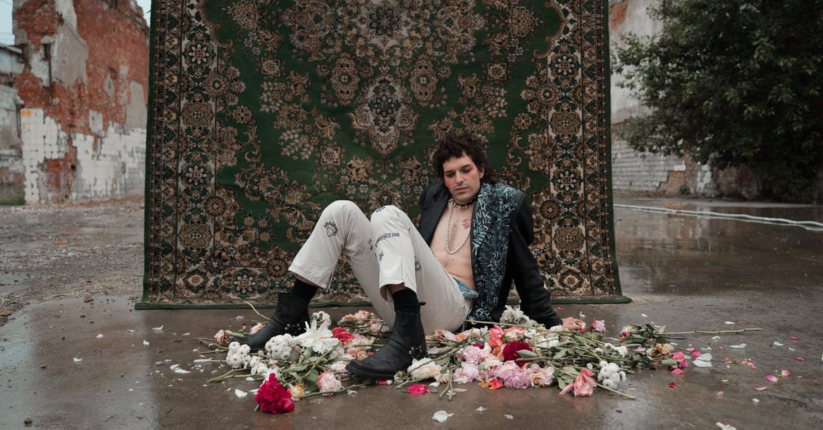 Is Billy Breckenridge gay? - Man and Woman Sitting on Floor With Flowers