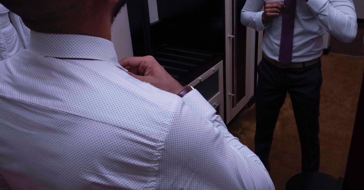 Is Breacher wearing a European style necktie to point to Schwarzenegger's heritage? - Photo of Man Wearing Dress Shirt While Standing in Front of Mirror