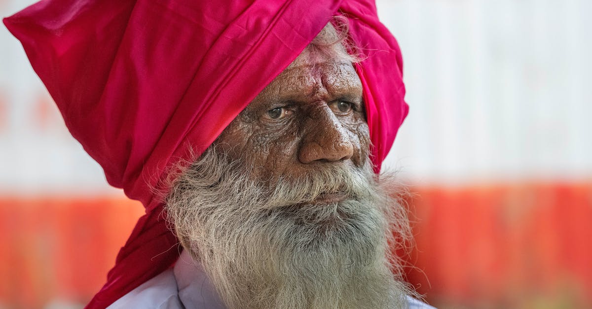 Is God really a Red Sox fan? - Thoughtful wise elderly Indian Sikh with beard in turban