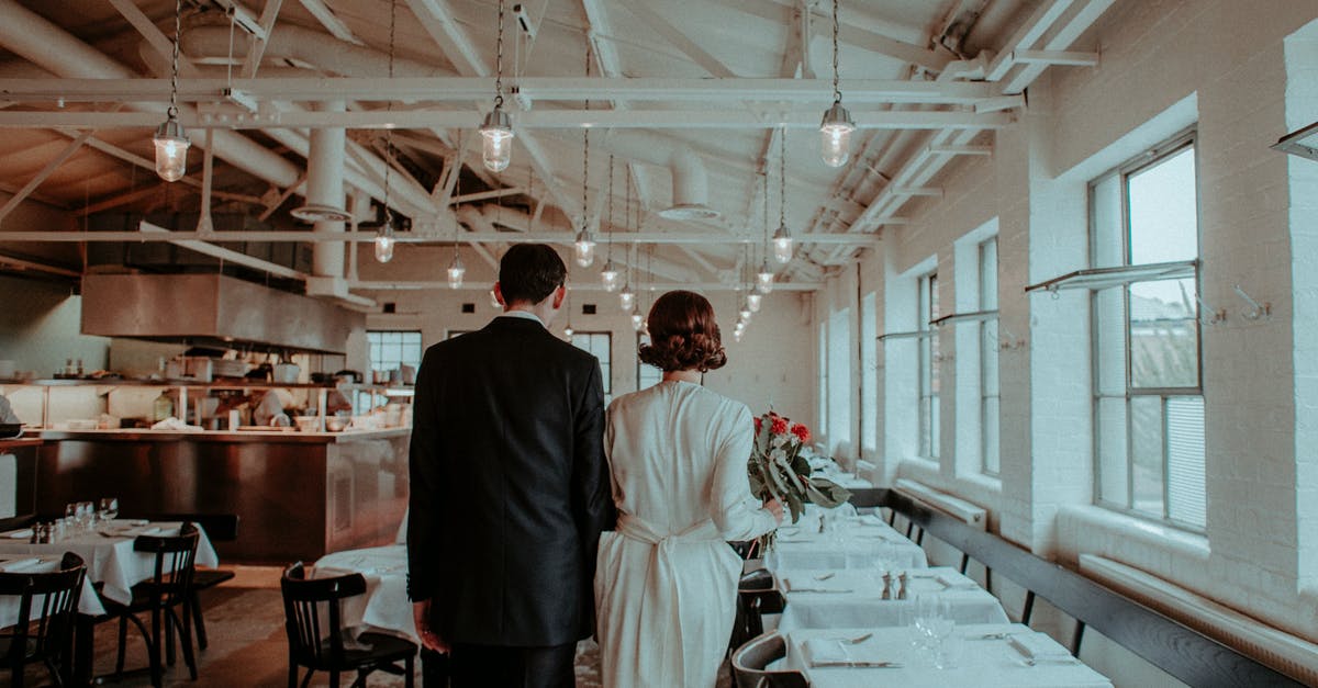 Is it common for a groom to walk the bride down the aisle? - Newlyweds walking in empty restaurant
