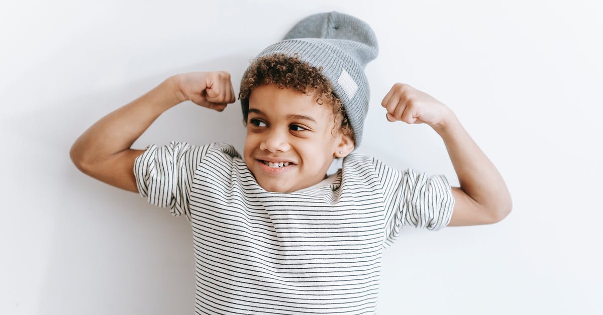 Is it legal to show kids reaching orgasm with clothes on? - Cheerful black boy showing biceps