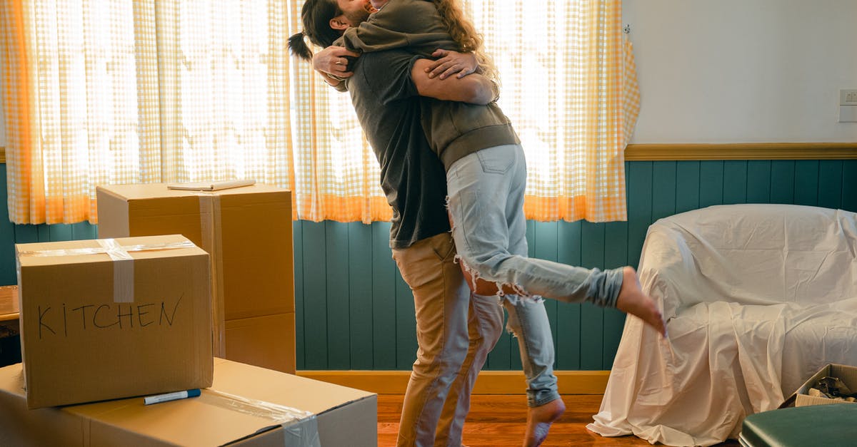 Is it realistic for Beck to chew out Roman in the beginning of The Negotiator? [closed] - Side view full body barefoot young bearded male in casual clothes standing against window and lifting laughing girlfriend up during relocation and unpacking things from cardboard boxes