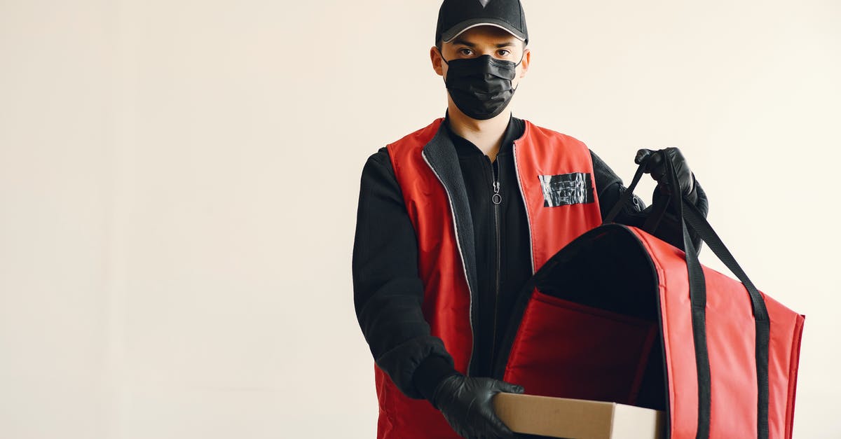 Is it really possible to put a virus in a machine you don't know? [duplicate] - Young pizza delivery man in uniform and protective mask
