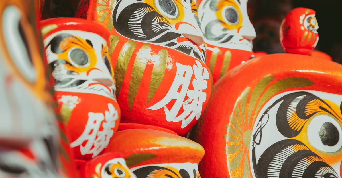 Is Lilo and Stitch set in a real city? - Collection of traditional Japanese red painted daruma dolls depicting bearded man stacked together on local market on street in city