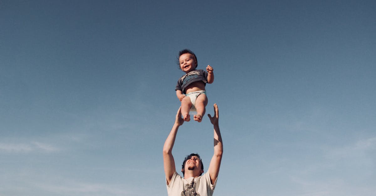 Is Noah Tronte Neilson's father? - Photo of Man in Raising Baby Under Blue Sky