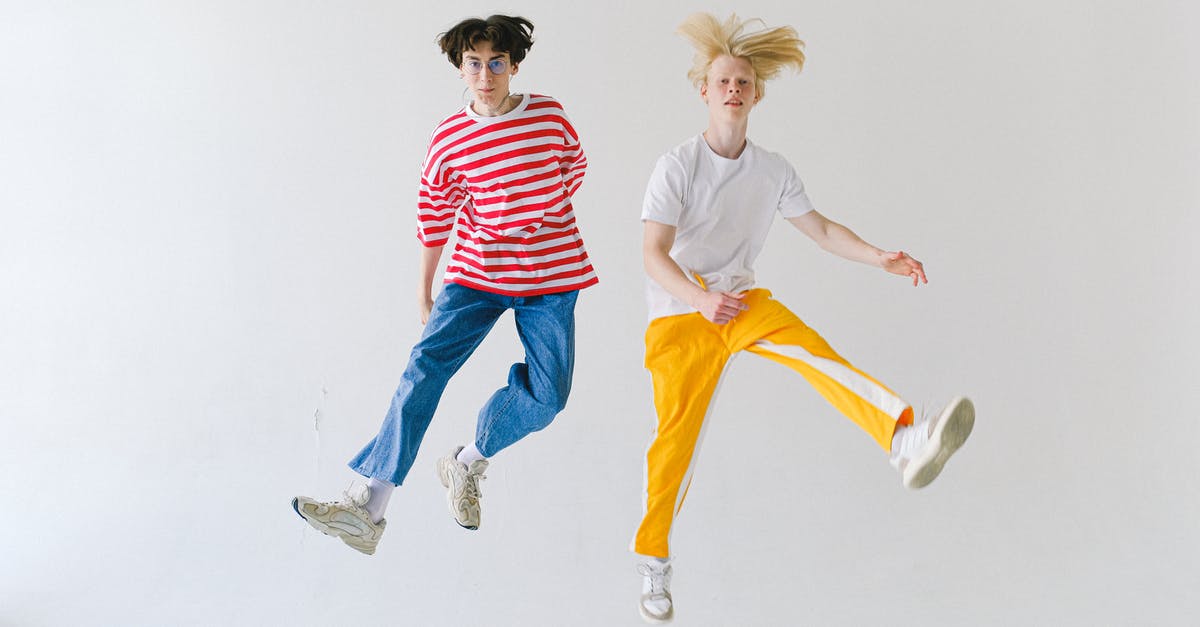 Is "White Men Can't Jump" a dream? - Full body cheerful teenager friends in colorful wear jumping high on white background and looking at camera