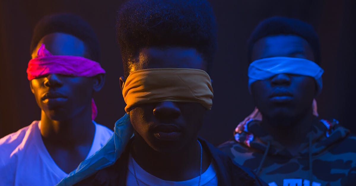 Is the blind man a previous version of Morpheus? - Anonymous cool ethnic male band with Afro hairstyle and covered eyes illuminated by artificial light
