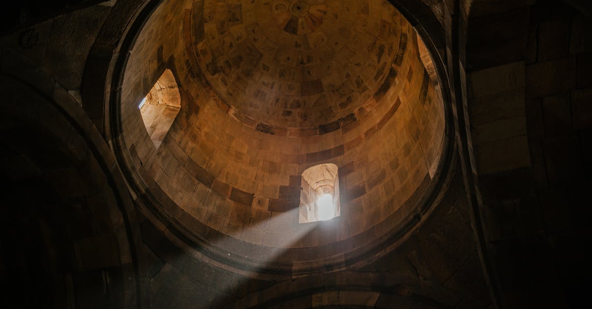 Is The Good Place inspired by Swedenborg as a state of spirit rather than a Place? - From below of bright sunshine illuminating through window of dome in ancient stone cathedral