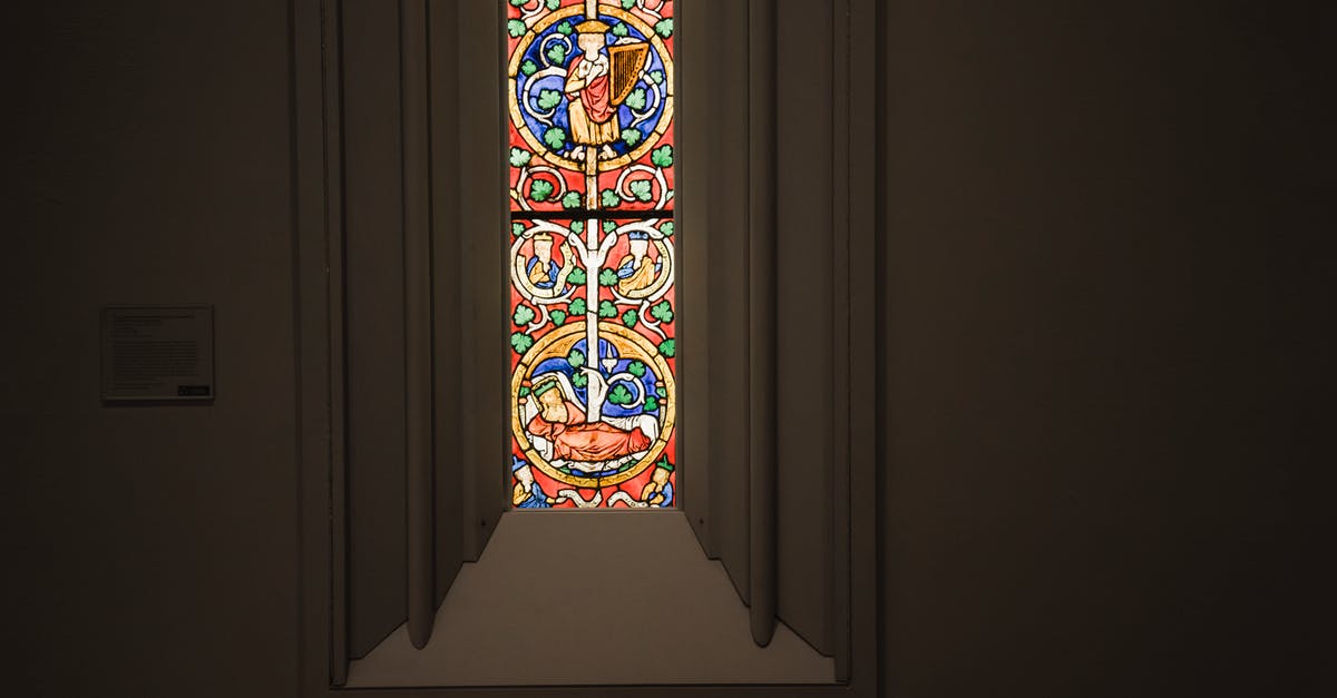 Is The Good Place inspired by Swedenborg as a state of spirit rather than a Place? - Narrow window with multicolored ornamental leaded glass in stucco frame located in dark grand cathedral