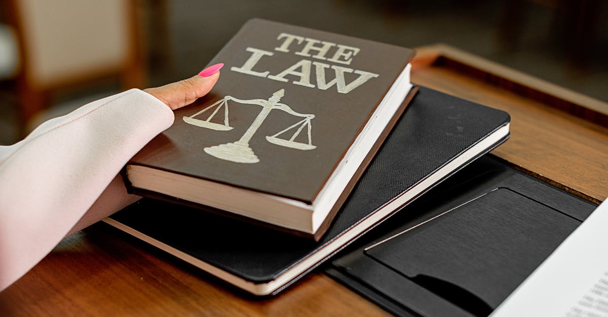 Is the lawyer in on the scam? - Black Book on Brown Wooden Table