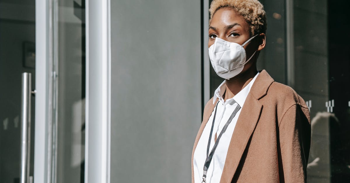 Is the name 'Clitterhouse' in 'The Amazing Doctor Clitterhouse' a rude joke? - Serious young African American female manager with short dyed hair in stylish outfit and medical mask standing on street near contemporary building and looking away during coronavirus pandemic