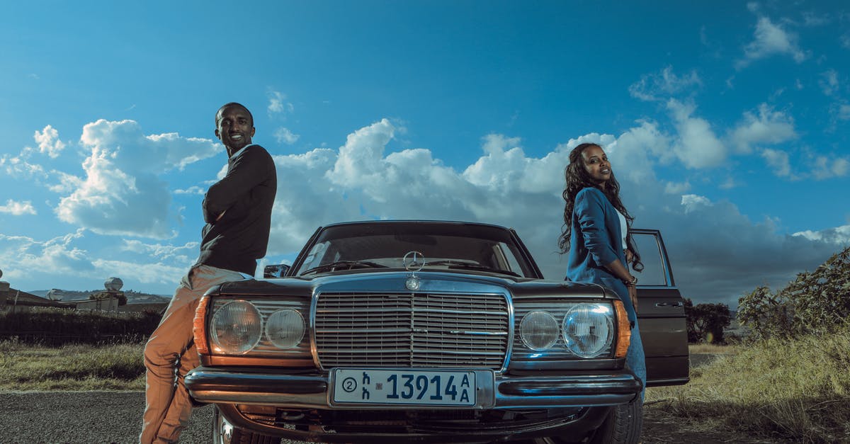 Is there a name for the side angle car crash scene? - Stylish black couple standing near retro car in countryside