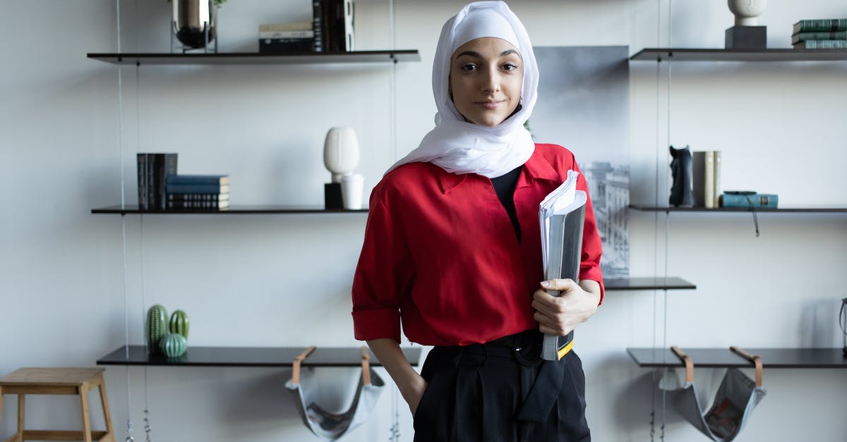 Is there a significance to the different colored ink in Cassie's notebook in Promising Young Woman? - Confident young Muslim lady in hijab and casual outfit standing in light apartment with notebooks near shelves with different decorative objects and small wooden stand while looking at camera