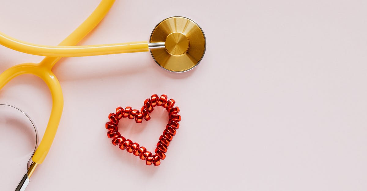 Is there a symbolic meaning behind the Spiral Hill in The Nightmare Before Christmas? - From above of yellow stethoscope near small red bead heart made for San Valentines Day on pale pink surface