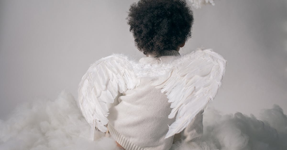 Is there any significance to the Angels' wing colours? - Anonymous boy in angel wings sitting on cotton cloud