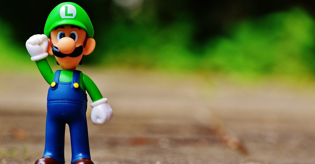 Is there any significance to the Disney character figurines? - Shallow Focus Photography of Luigi Plastic Figure