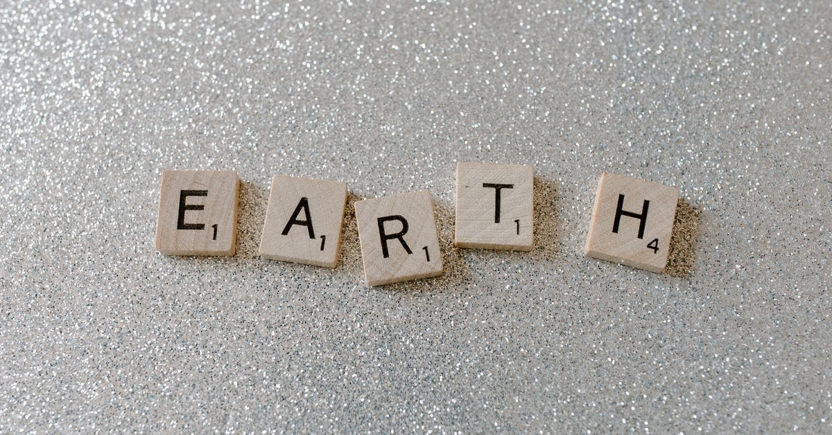 Is there any significance to the Earths' numbers? - Brown Wooden Letter Blocks on Gray Surface