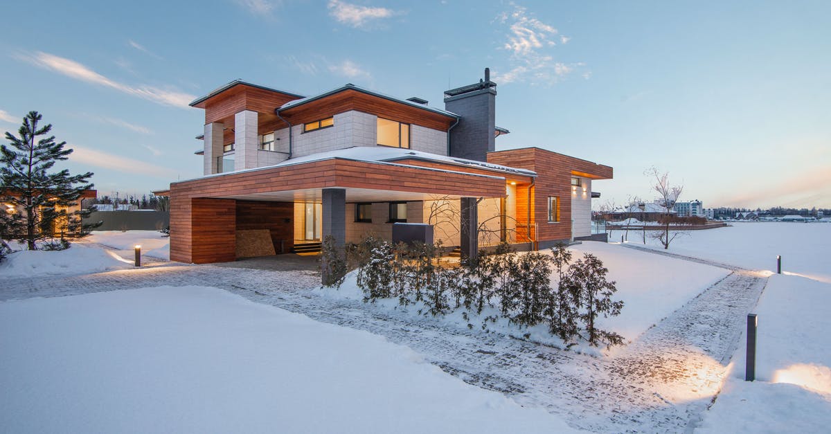 Is this a nod to new 52 or just a coincidence? - Exterior view of luxurious residential house with roofed parking and spacious backyard in snowy winter countryside