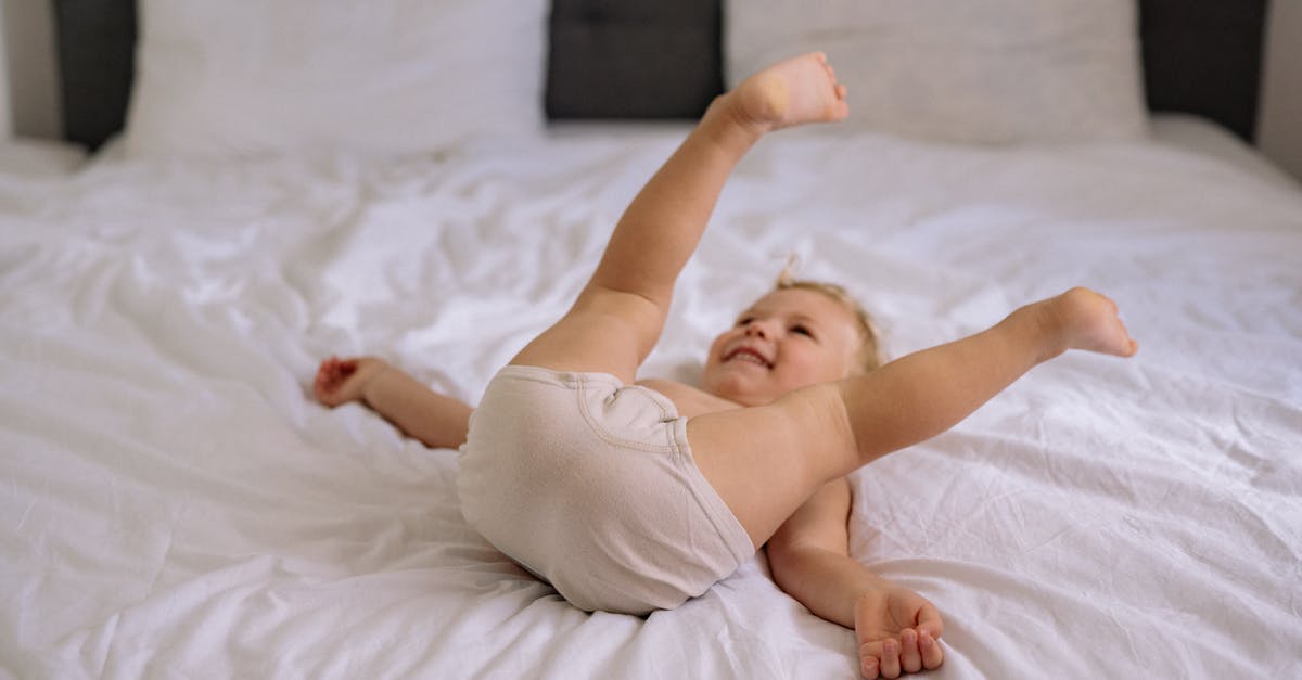 Is this a time loop? - Baby in White Tank Top Lying on White Bed