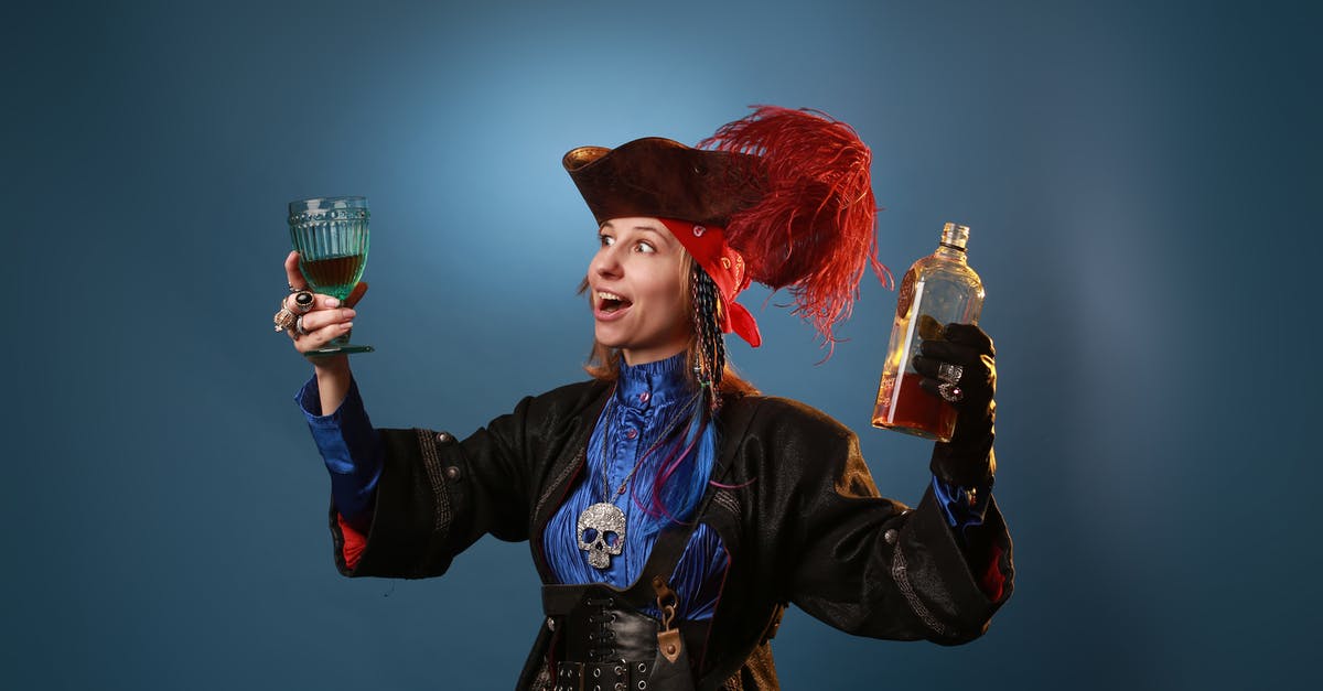 Is this pirate in the background a young Edward Teague? - Amazed woman in pirate costume and pendant with decorative skull holding vintage glass and bottle of booze