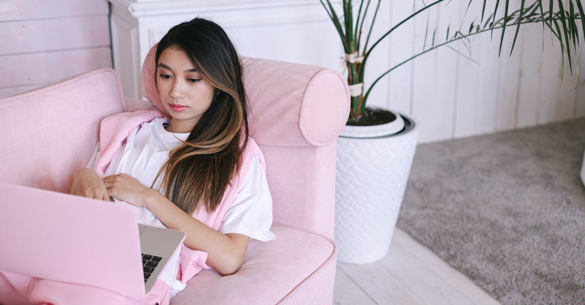 Isn't Lister an Orphan? - Woman in Pink Shirt Sitting on Sofa Using Macbook