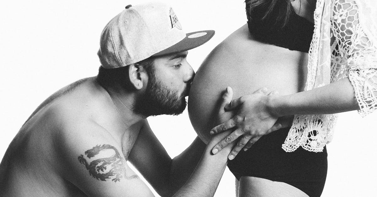Louis's reaction to his wife's pregnancy - Grayscale Photography of Man Kissing Woman's Pregnant Bell