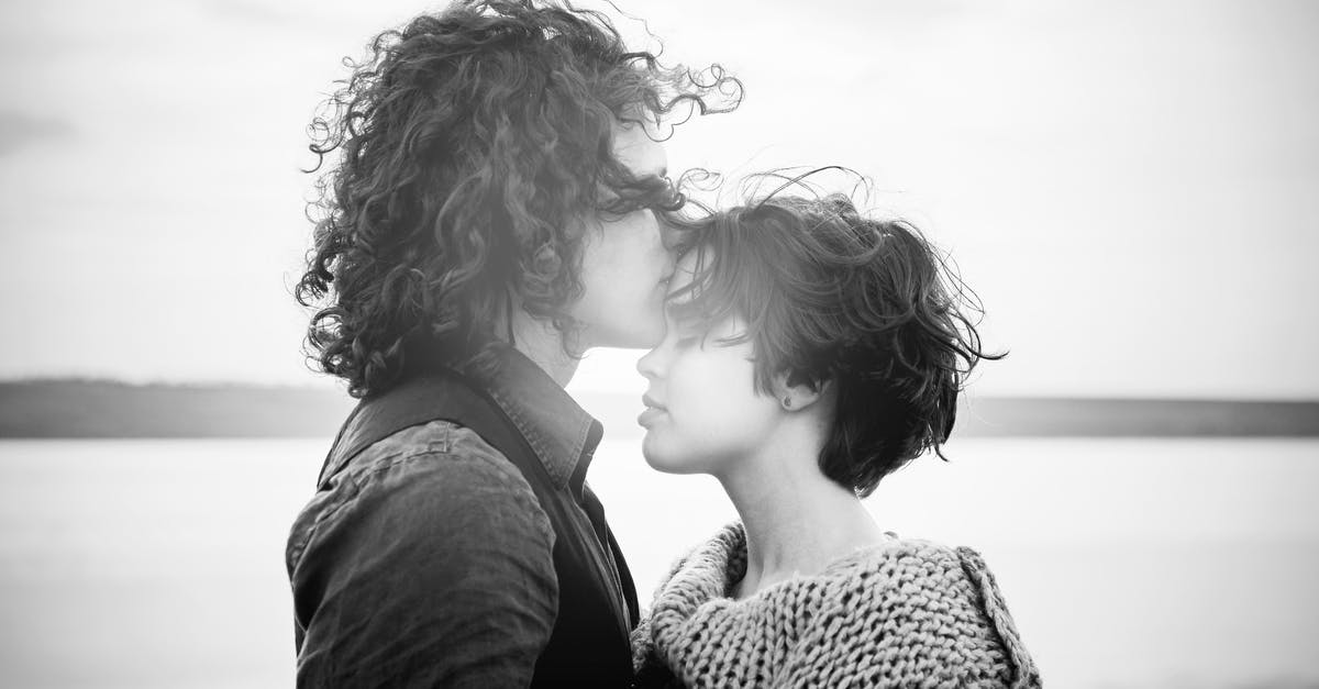 Love movie where a guy cheats on the female protagonist [closed] - Grayscale Photo of Man Kissing Woman's Forehead