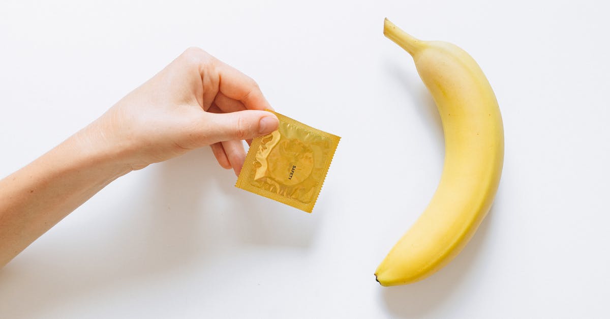 Mimi knows she has HIV but still wants to have sex with Roger? - Person Holding Condom Next to Banana