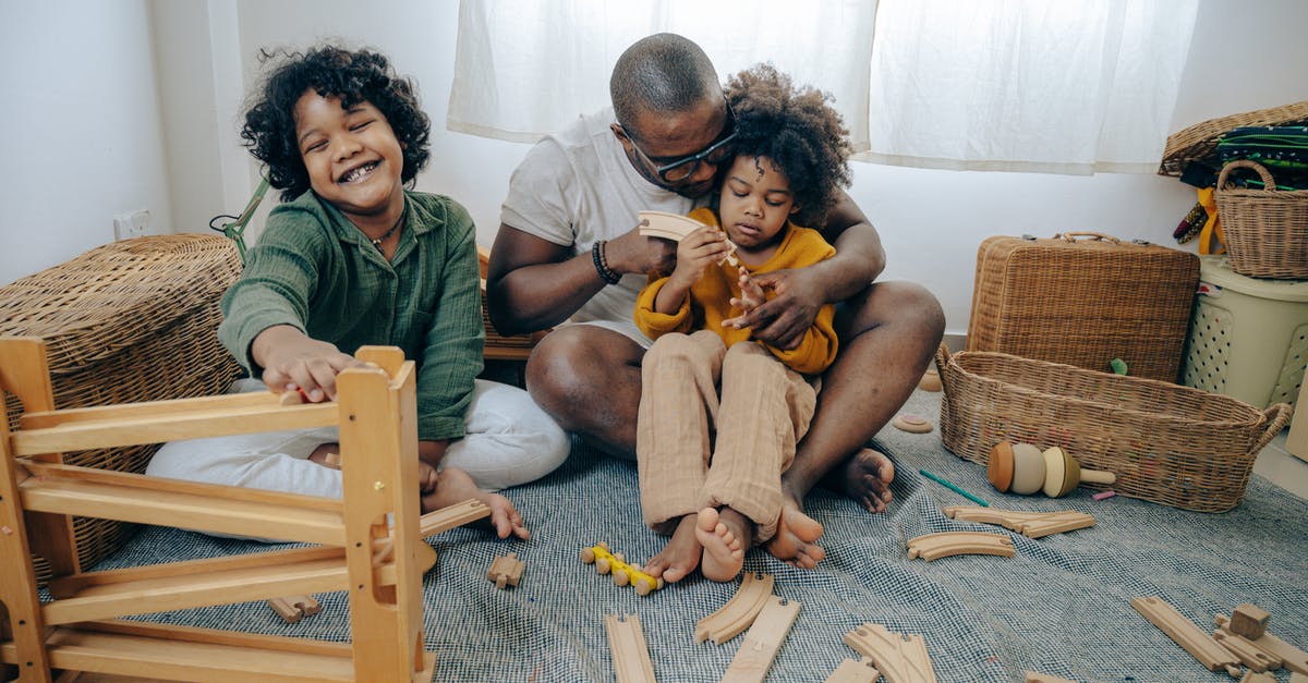 Movie about a white father being killed by a black man causing them to become skinheads? [closed] - Cute black girls collecting wooden details of constructor with father while spending weekend together at home