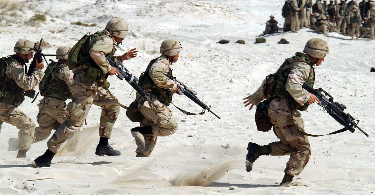 Movie about army reserve soldiers on rotation and they are stranded with combat knives [closed] - 5 Soldiers Holding Rifle Running on White Sand during Daytime