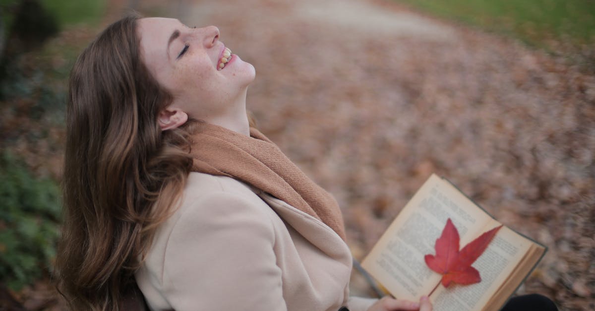 Movie about restaurant where girl fall in love with chef, Language-English [closed] - Cheerful young woman with red leaf enjoying life and weather while reading book in autumn park