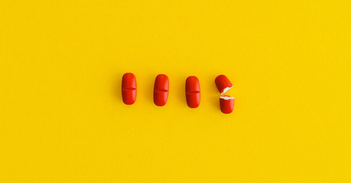 Movie asking the scientist what should be the color of the pill they have developed, deciding on orange/purple? [closed] - Orange Pills on Yellow Surface