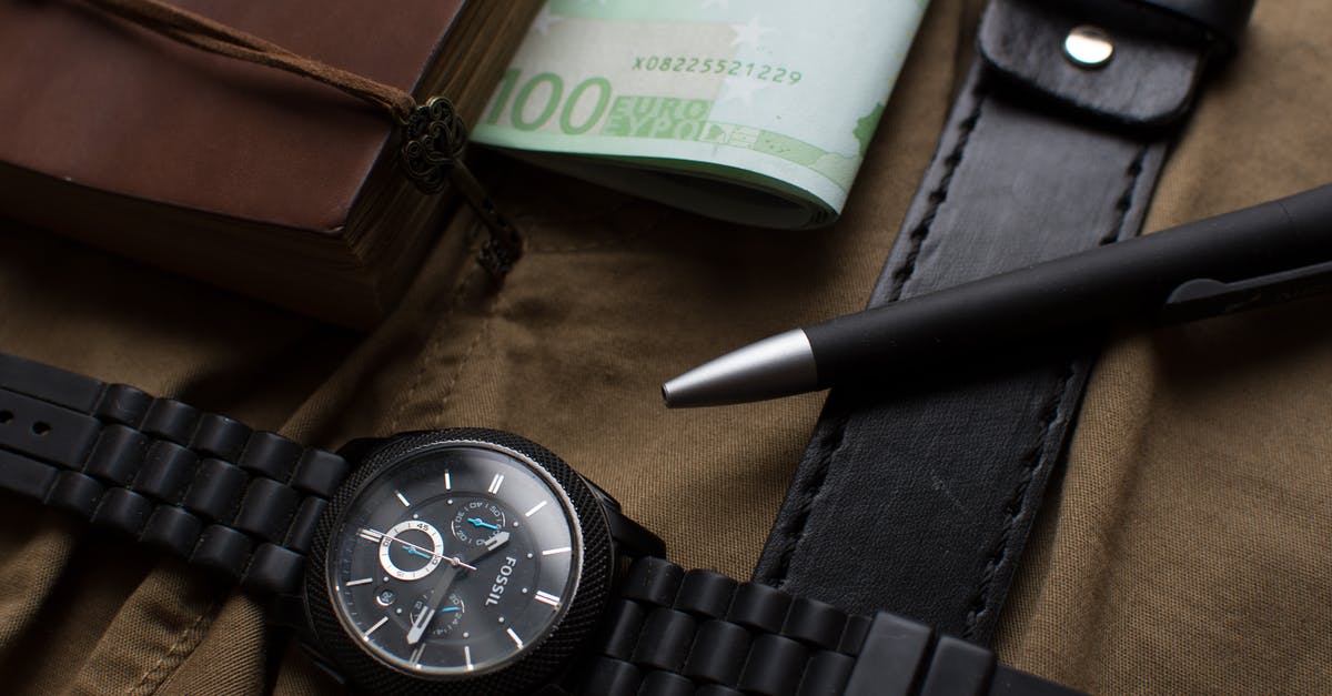 Movie in which time is money [closed] - 100 Euro Banknote Beside Round Black Chronograph Watch