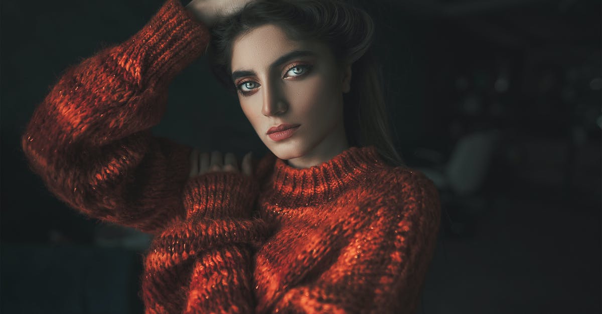 Of whom are the photo portraits in Larry's office? - Beautiful woman in a red sweater