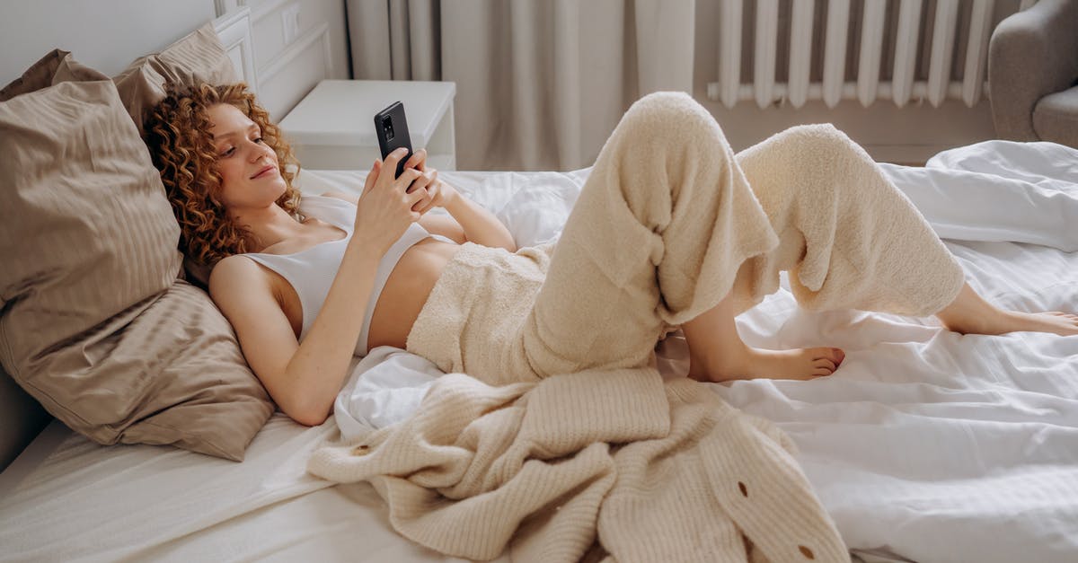 Patrick's Bed Sheets - Woman in White Crop Top Lying Down on Bed Using Smartphone