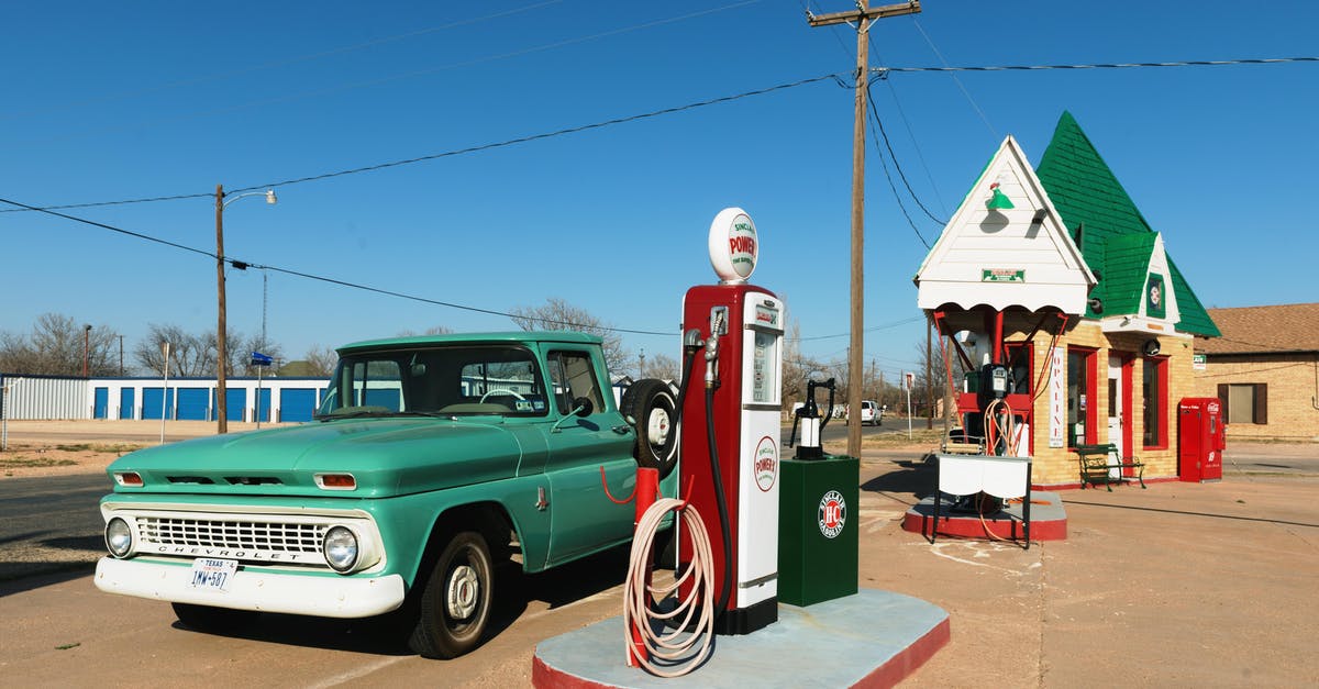 Petrol extinction in Futurama - Green Single-cab Pickup Truck Beside a Gas Pump Station