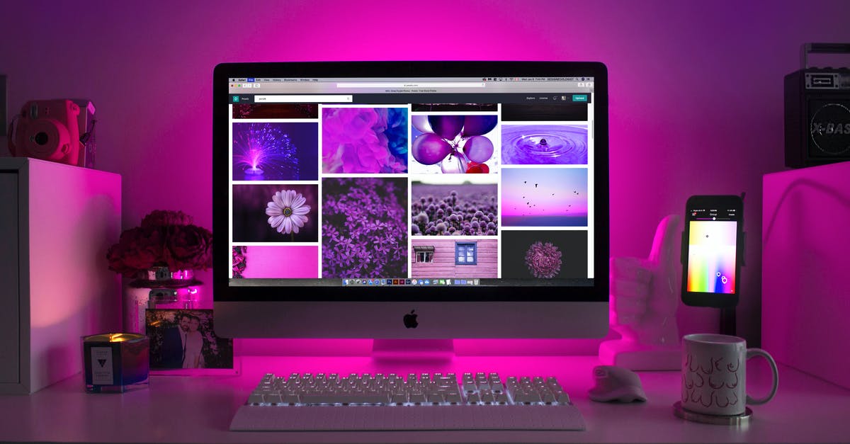 Raj's computer monitor and keyboard - Silver Imac Displaying Collage Photos
