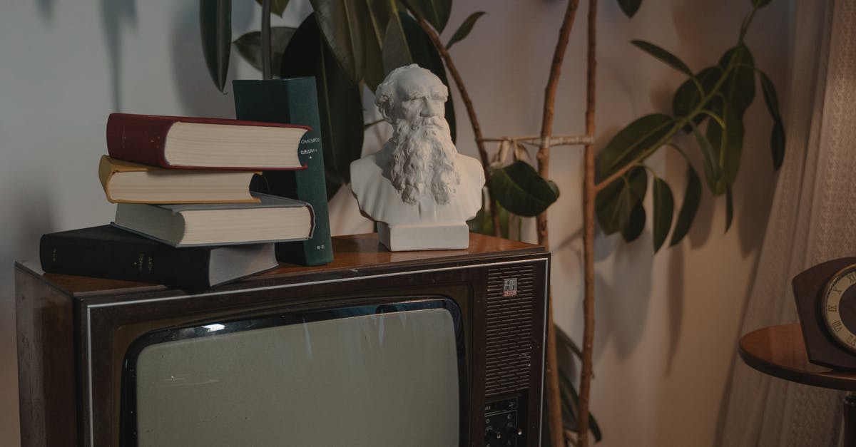 Roman Mysteries: differences between books and TV adaptation? - Stacked Books and a Head Bust on Top of CRT television 