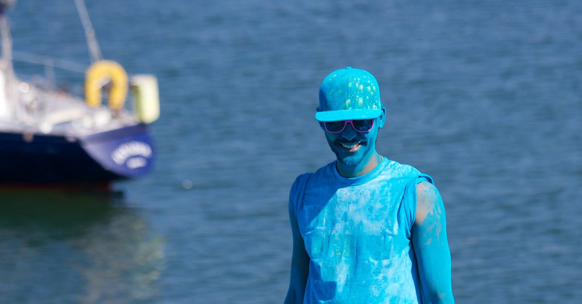 Sculptor smurf and sledgehammer smurf - Man Covered With Blue Paint Near Body of Water