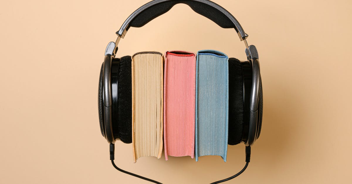 Shooting films silently and adding the sound afterwards - Black Corded Headphones with Colorful Books in Between