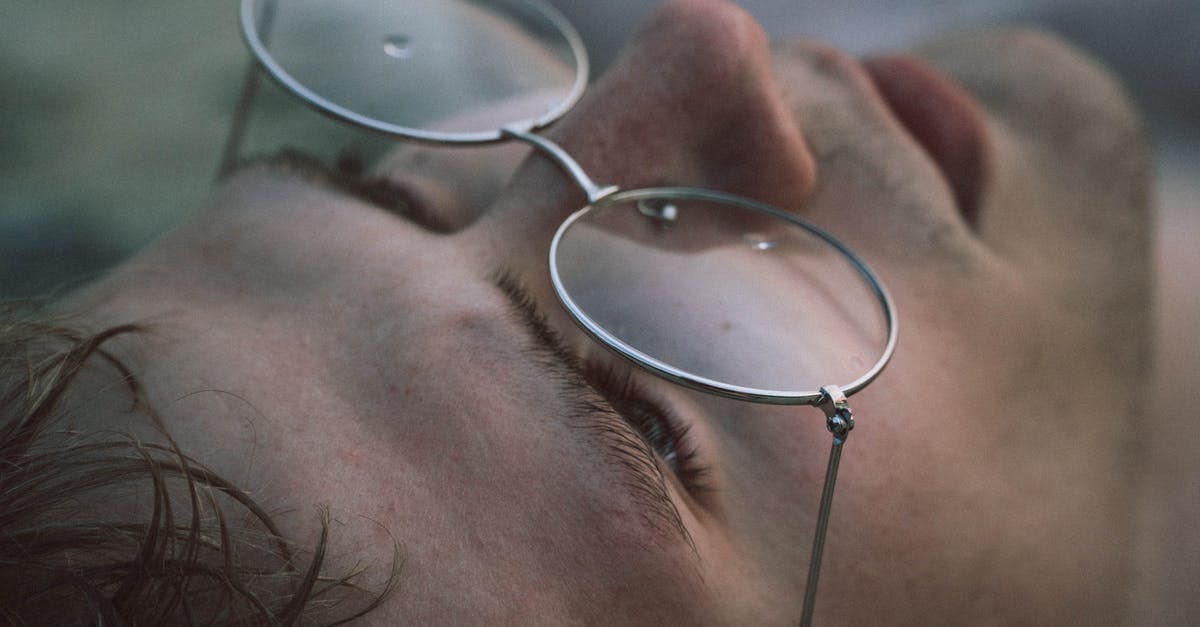 Significance of Man with a piece missing cake in Shape of Water - Closeup of crop young male in eyewear with pure water drips looking up on blurred background