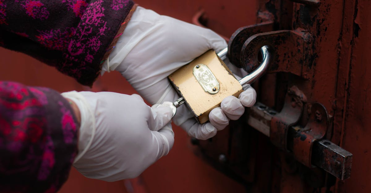 Significance of the door Levee is trying to unlock - Person Holding Gold Padlock With Key
