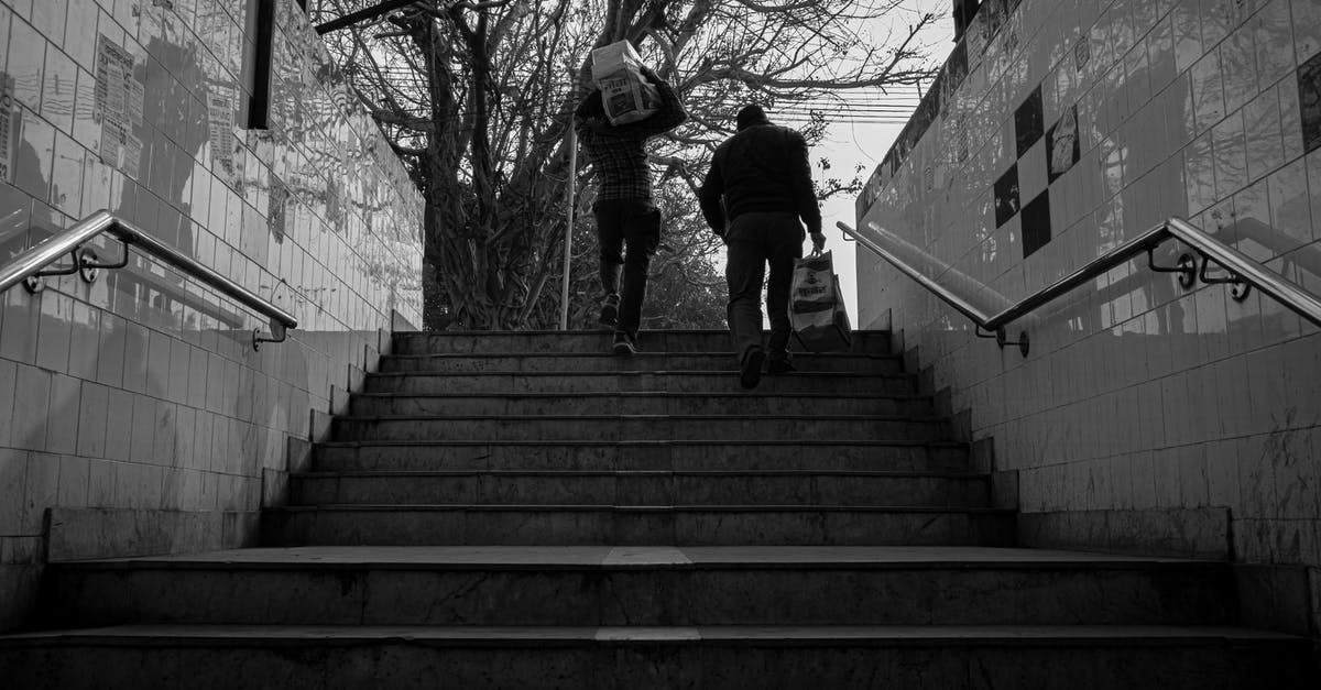 Song in Yes Man as Carl runs up the stairs before Jumper - Grayscale Photo of Man Walking on Stairs