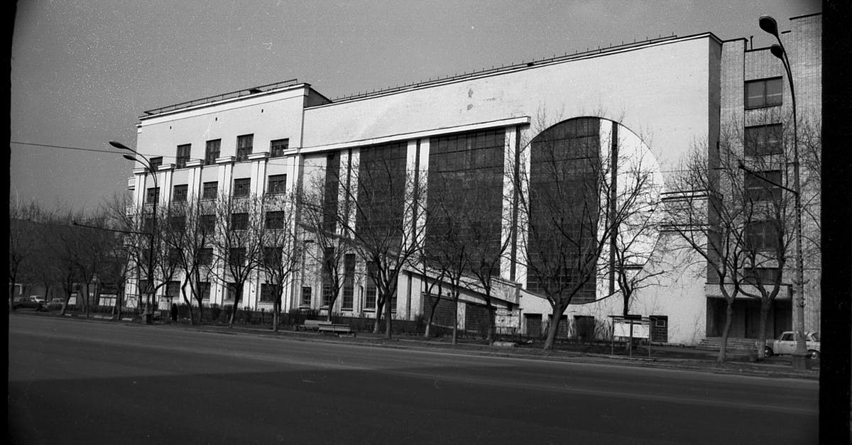Stanley Kubrick's view on the structure of a film - Black and white of aged multistory garage building with symmetric windows located near empty asphalt road in Moscow
