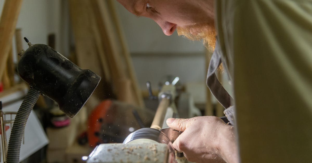 Subtitling Standards - Man Working At Workshop Holding a Metal Tool